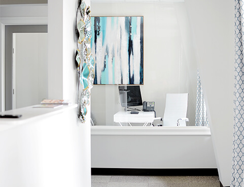 Our office meeting room with blue watercolor painting and white desk chair
